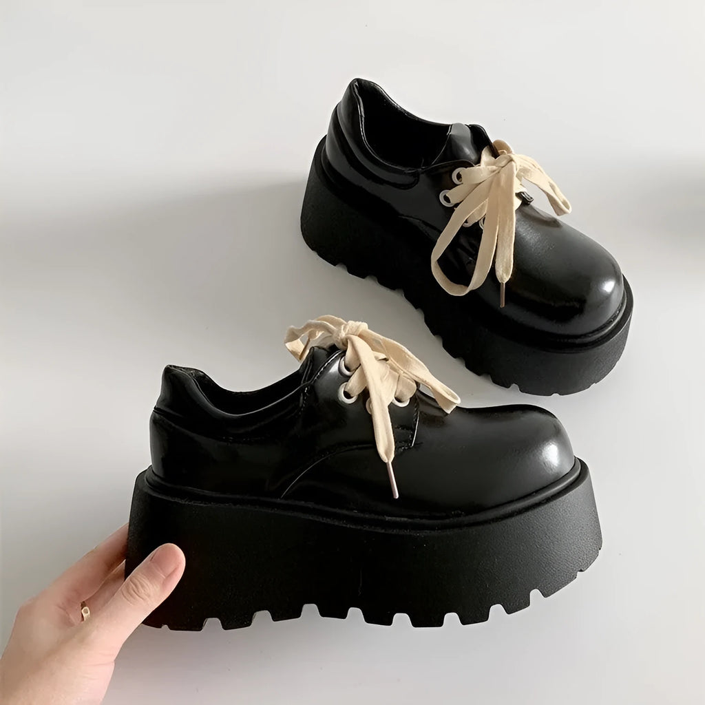 Matte black women's lace-up ankle boots with a chunky heel and thick sole.