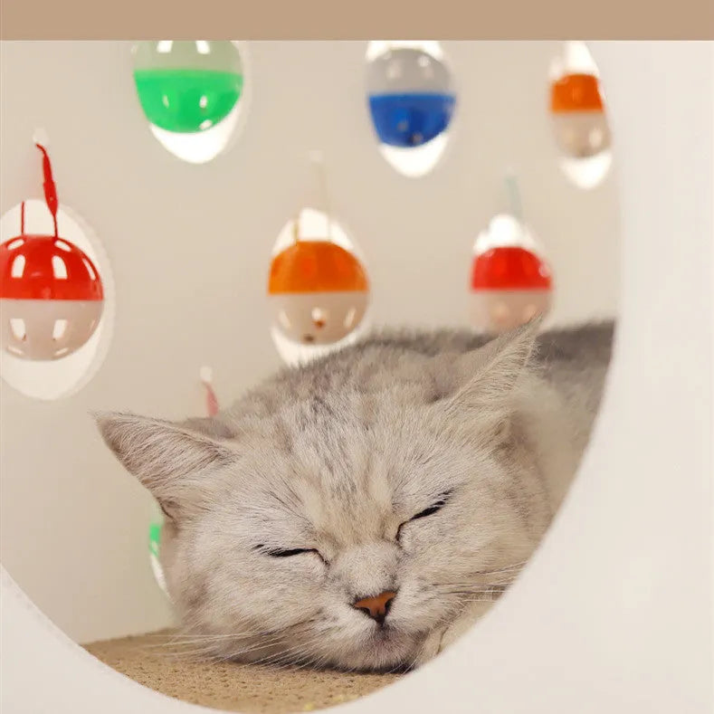 Plastic cat scratch board integrated with tunnel and nest containing bell ball