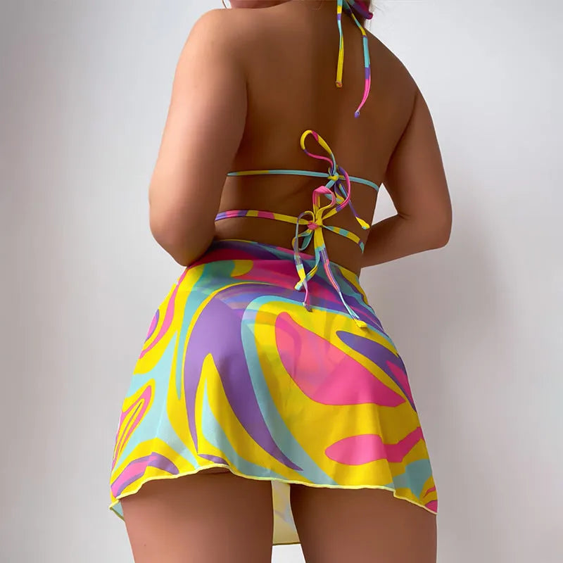 Yellow striped women's halter swimsuit with lace-up front, shown with matching high-waisted skirt and shorts.