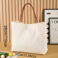 Beige white cotton canvas tote bag with sturdy handles on a plain background.