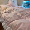 Mori style solid colour linen quilt cover and pillowcases on a bed, shown in a creamy green lace colour.