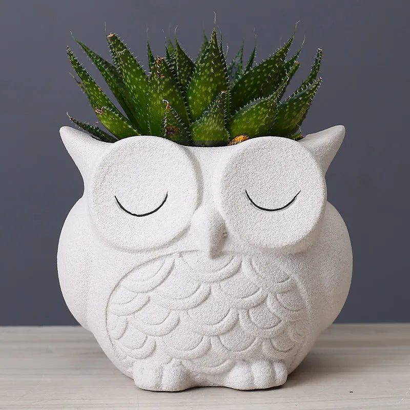 Handmade ceramic owl-shaped succulent plant pot in frosted light pink, shown from the front.