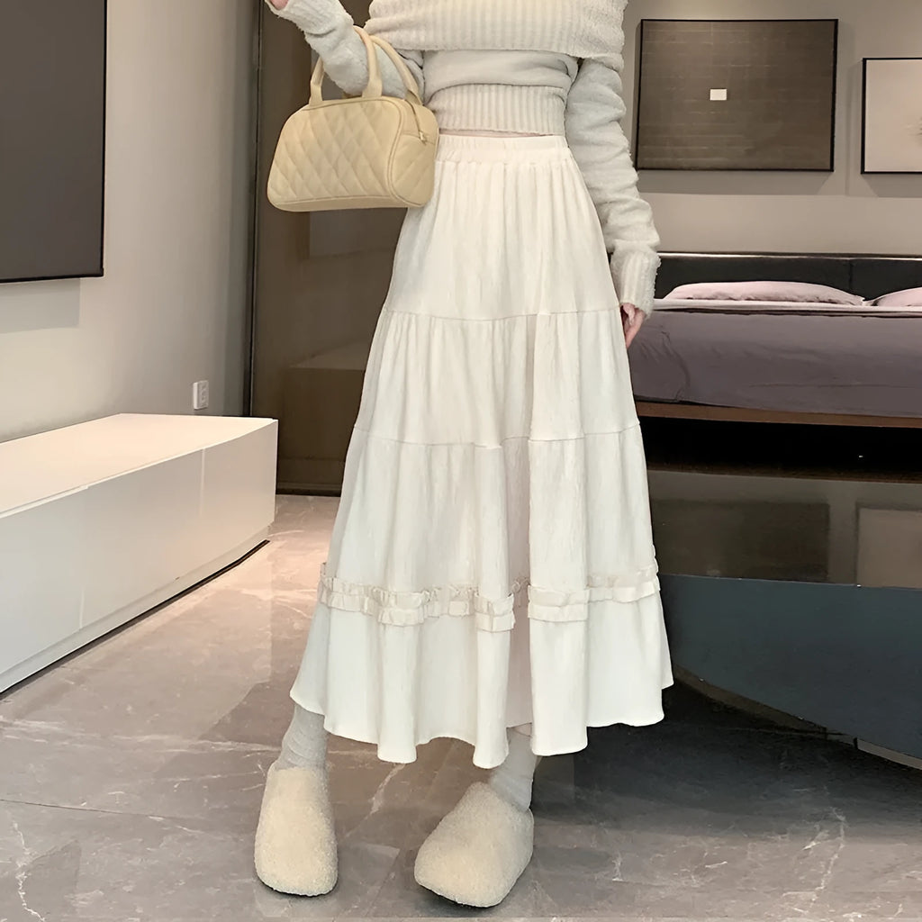 Korean style corduroy A-line midi skirt with elastic waistband in solid beige, black, or brown.