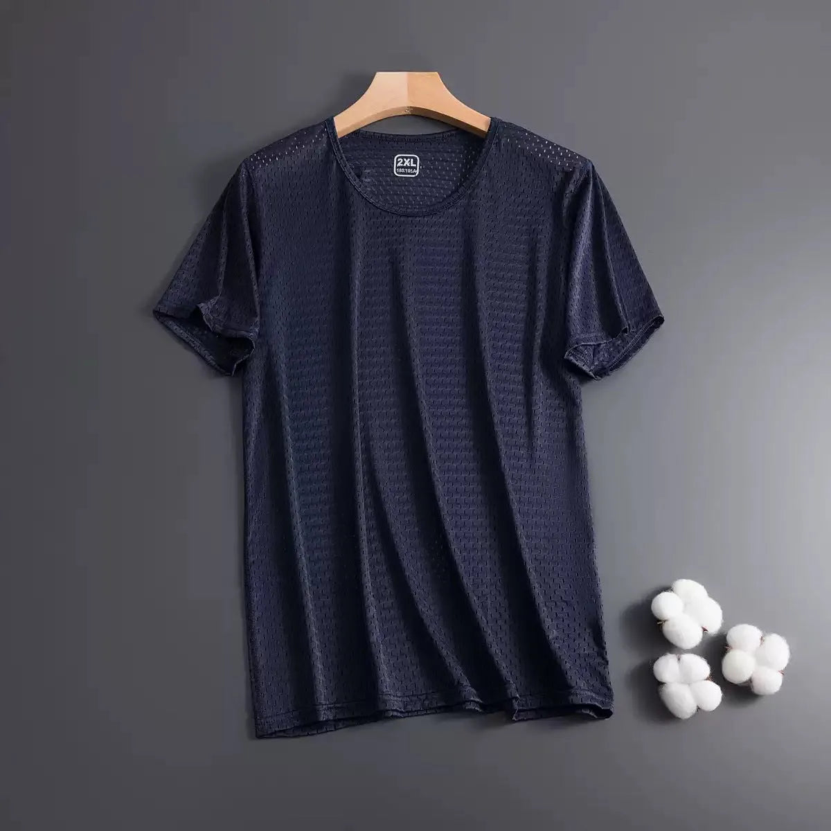 Man wearing a loose-fitting grey ice silk short sleeve crew neck T-shirt.