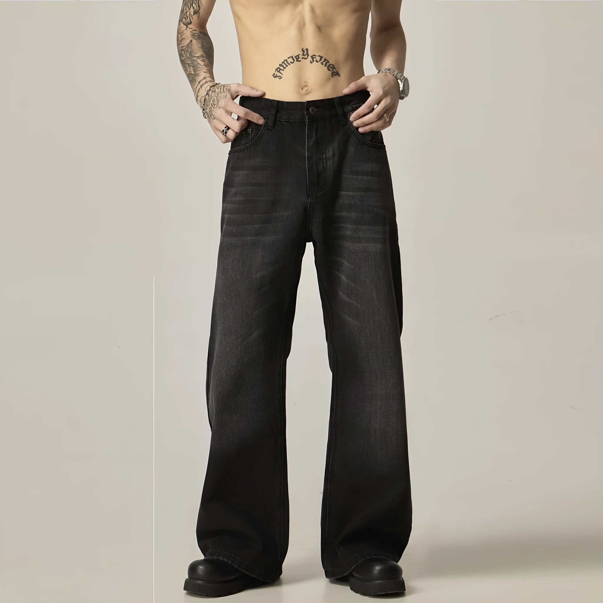 Black loose-fit straight-leg retro jeans with a zip fly on a neutral background.
