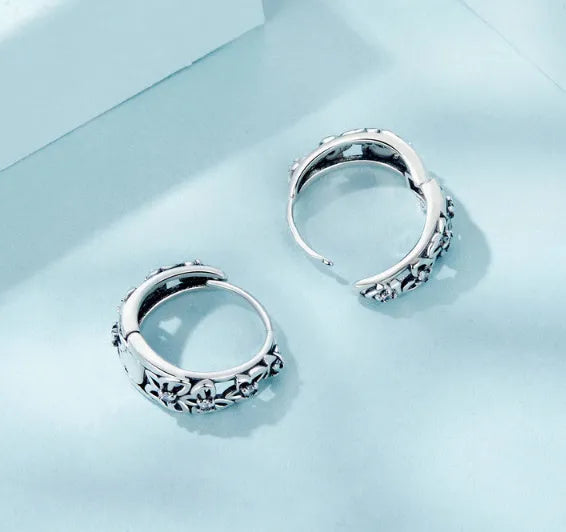 Sterling silver S925 retro hollow butterfly earrings with zircon details on a white background.