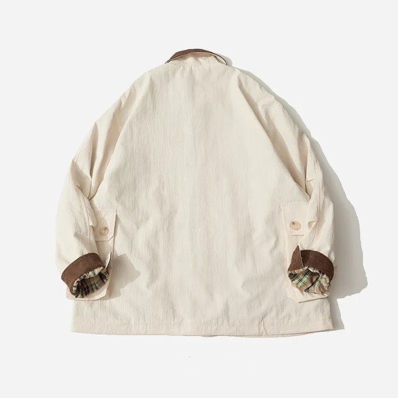 Green casual polyester jacket for men and women with side pockets on a hanger.