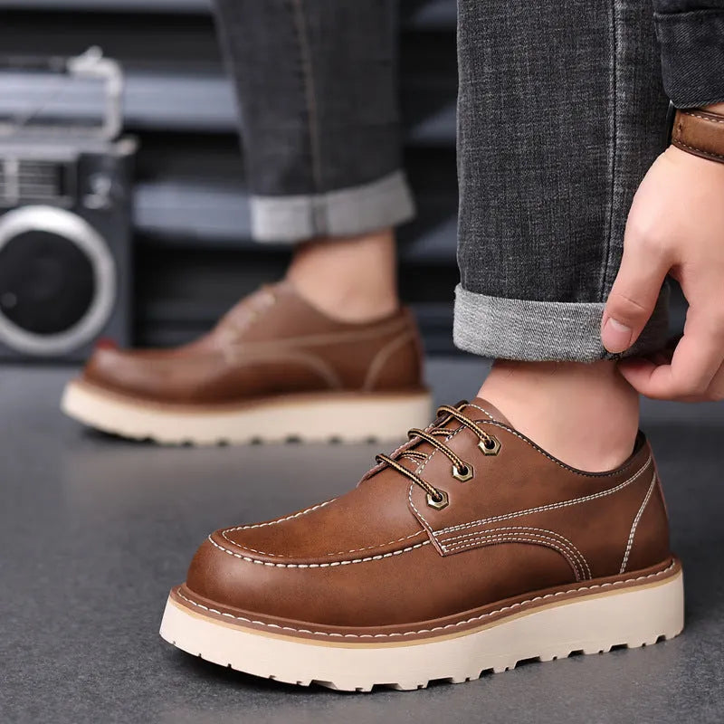 Men's black Martin boots with low-top retro design showing rubber sole and round toe shape