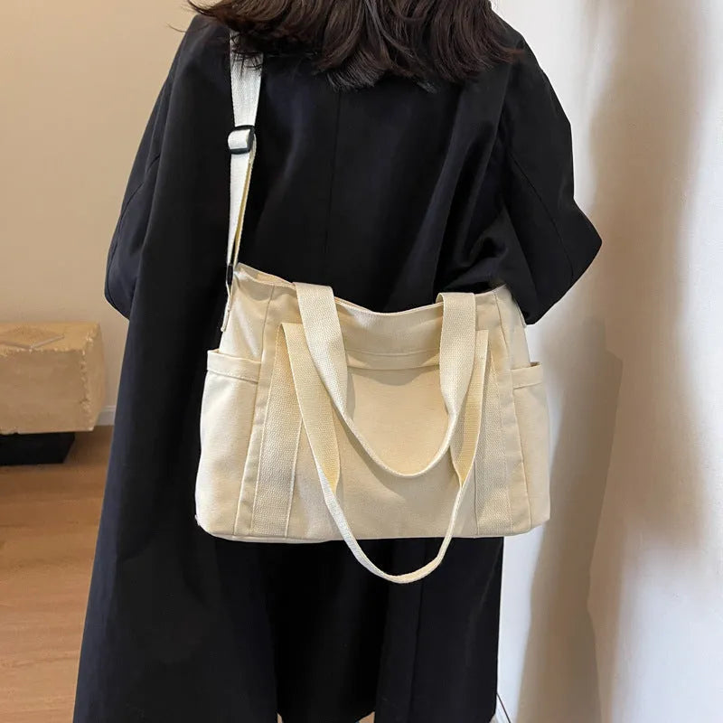Large solid colour polyester canvas shoulder tote bag for women with internal mobile phone pocket.