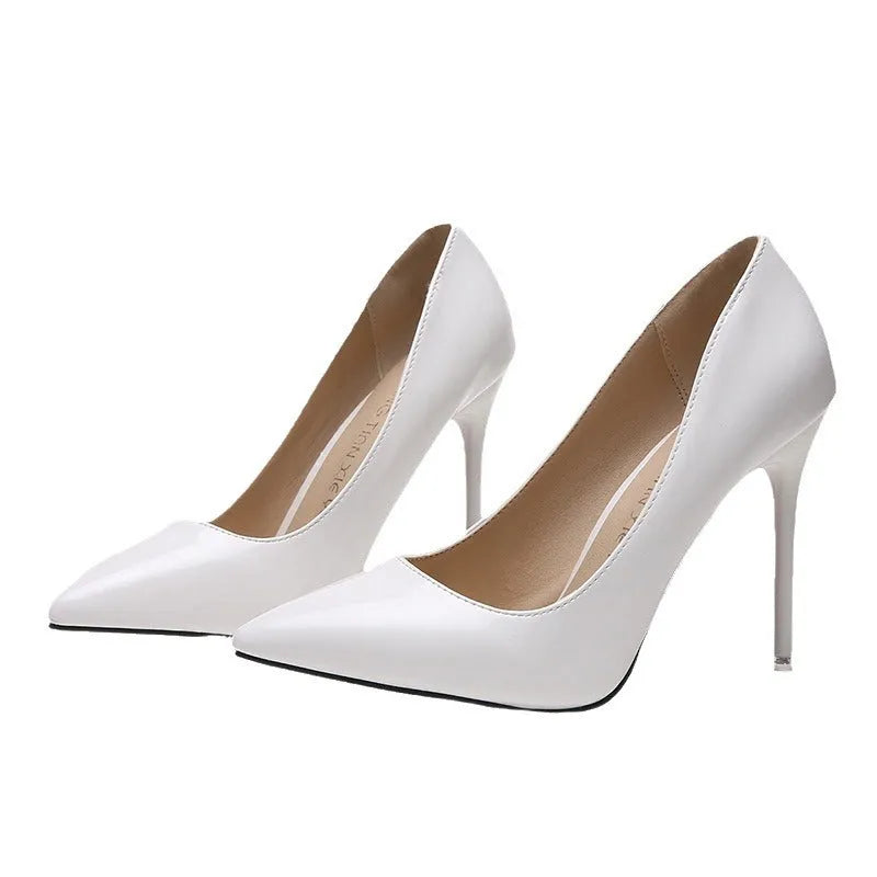 Women's pointed toe stiletto high heel pump in a solid colour with a buckle detail and rubber sole.