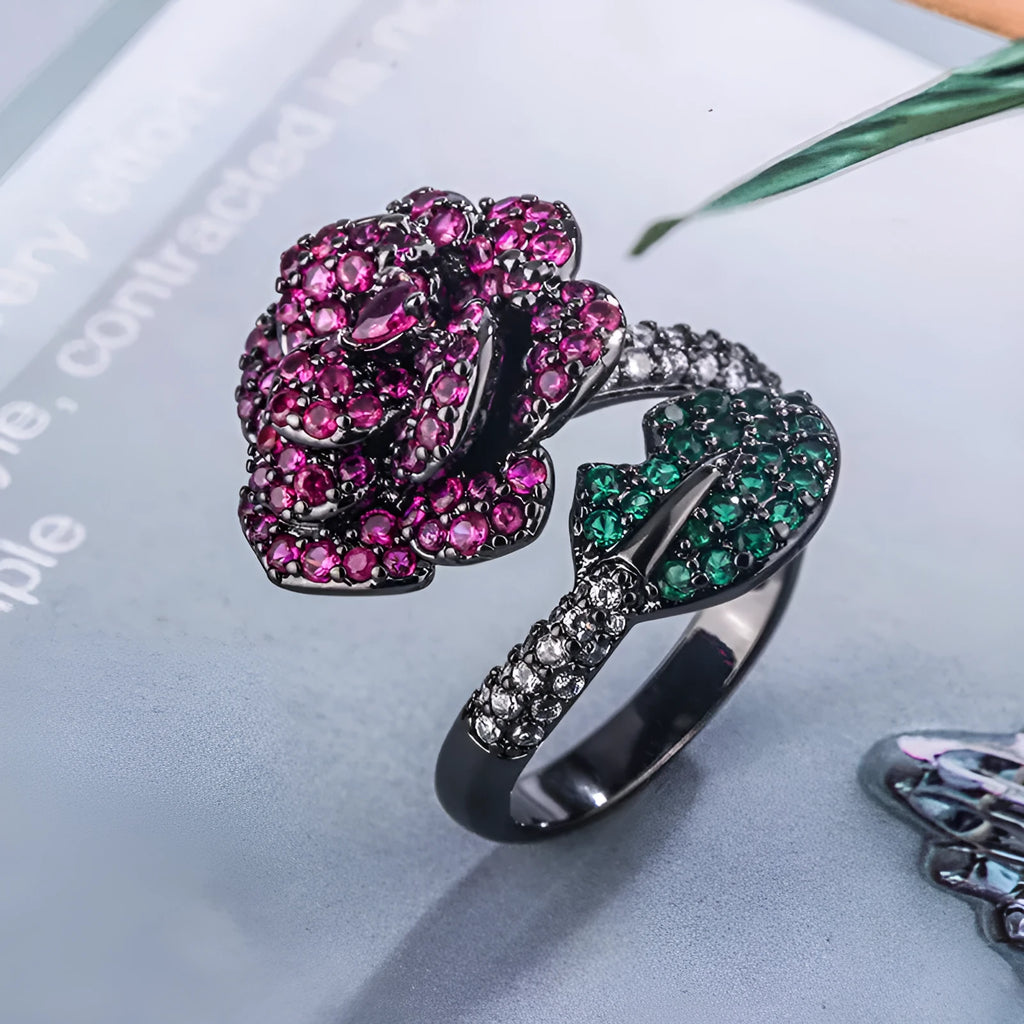 Gold-plated geometric flower ring with red simulated corundum stone on black gold finish
