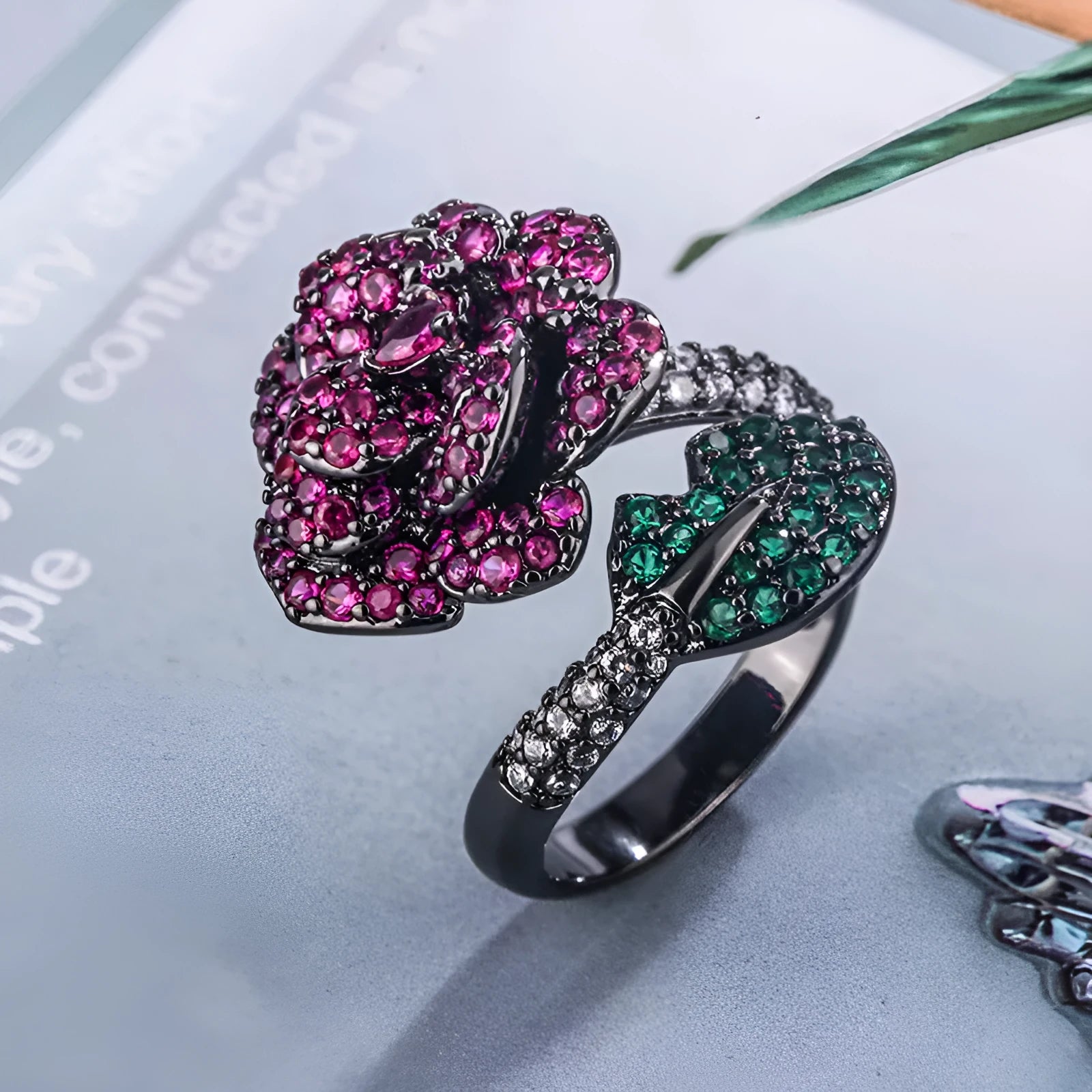Gold-plated geometric flower ring with red simulated corundum stone on black gold finish