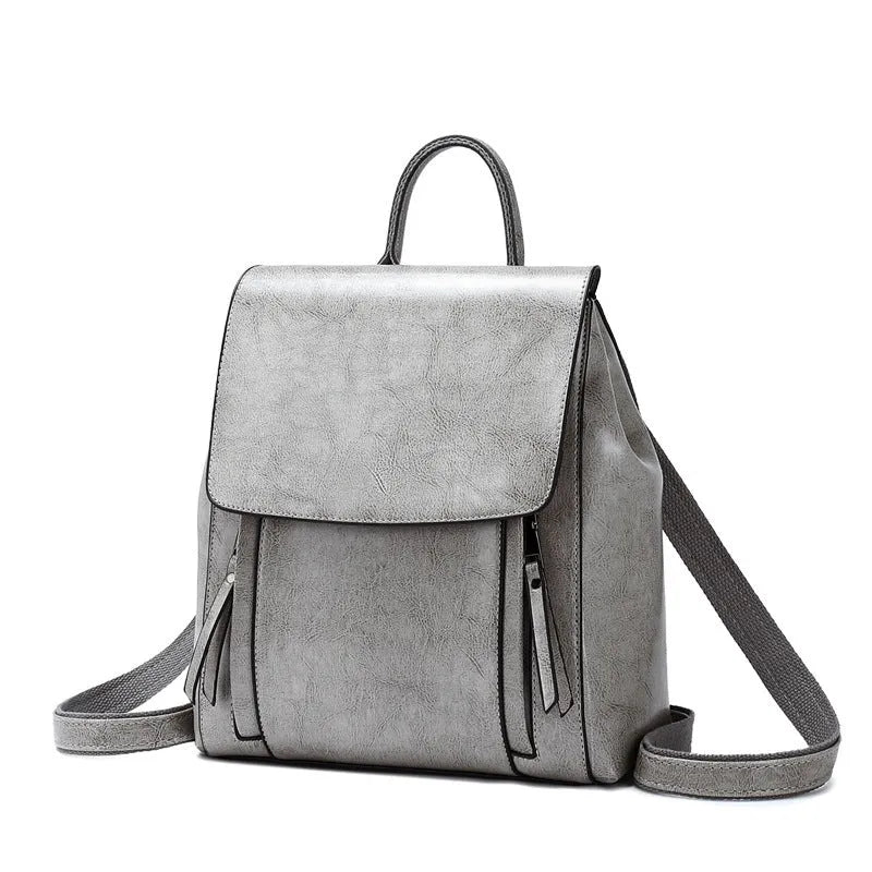 Large black genuine leather women's backpack with multiple internal pockets and double shoulder straps.