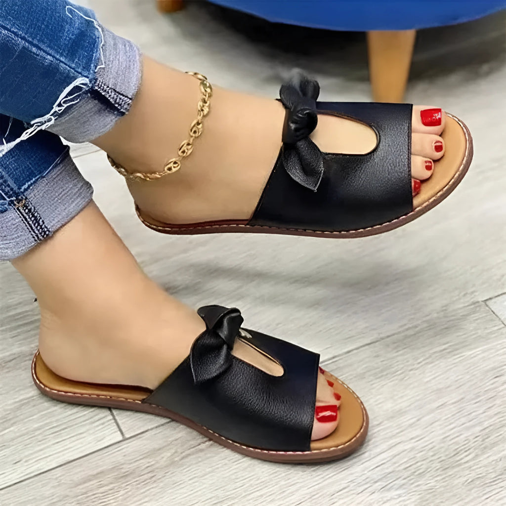 Women's fish mouth style sandals with a bow detail on the upper in black, pink, and gold colours