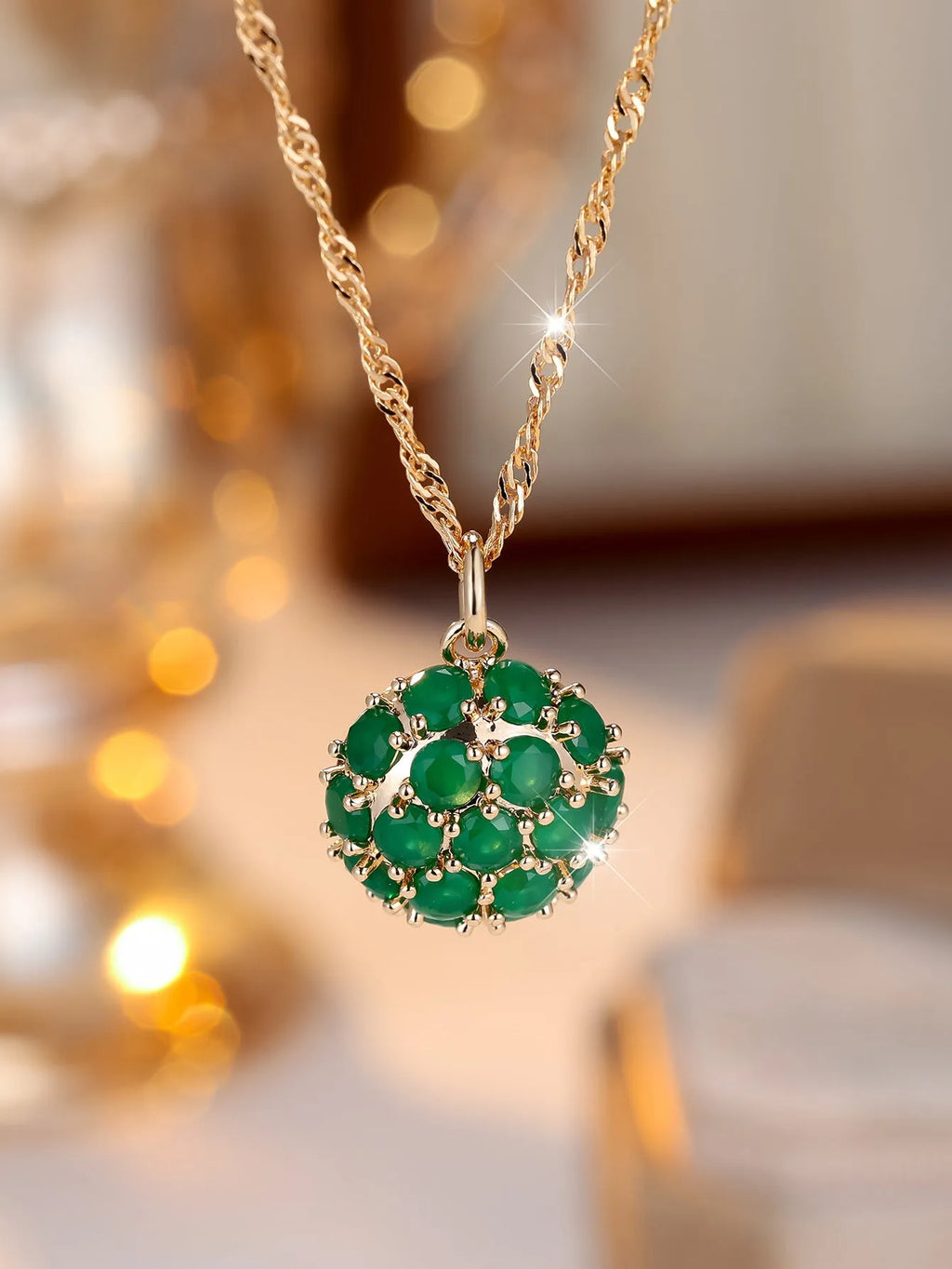 Round emerald and diamond pendant on an adjustable champagne gold electroplated copper chain necklace.