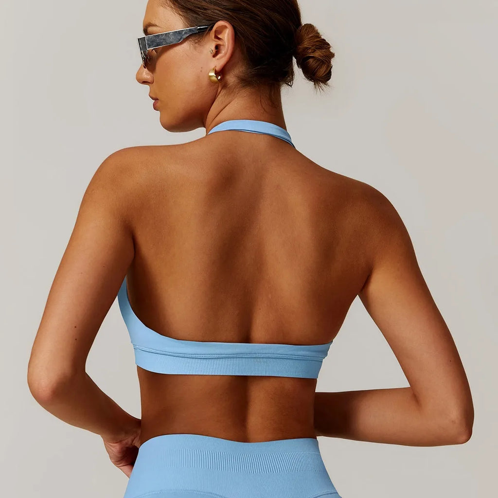 Women's black halter neck sports bra with medium support and built-in chest pads.