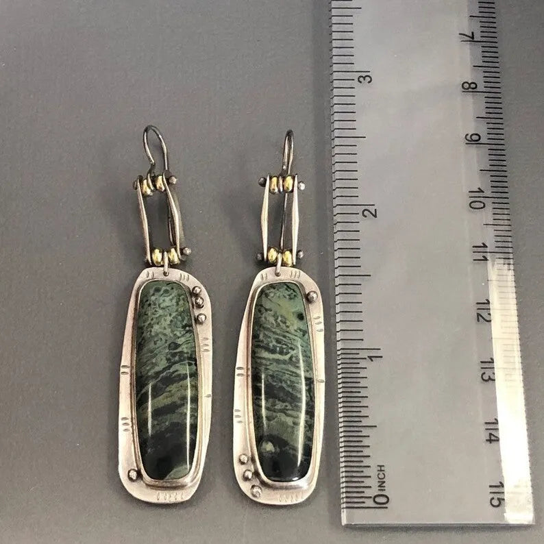 Pair of two-colour marble pattern geometric alloy earrings on simple background