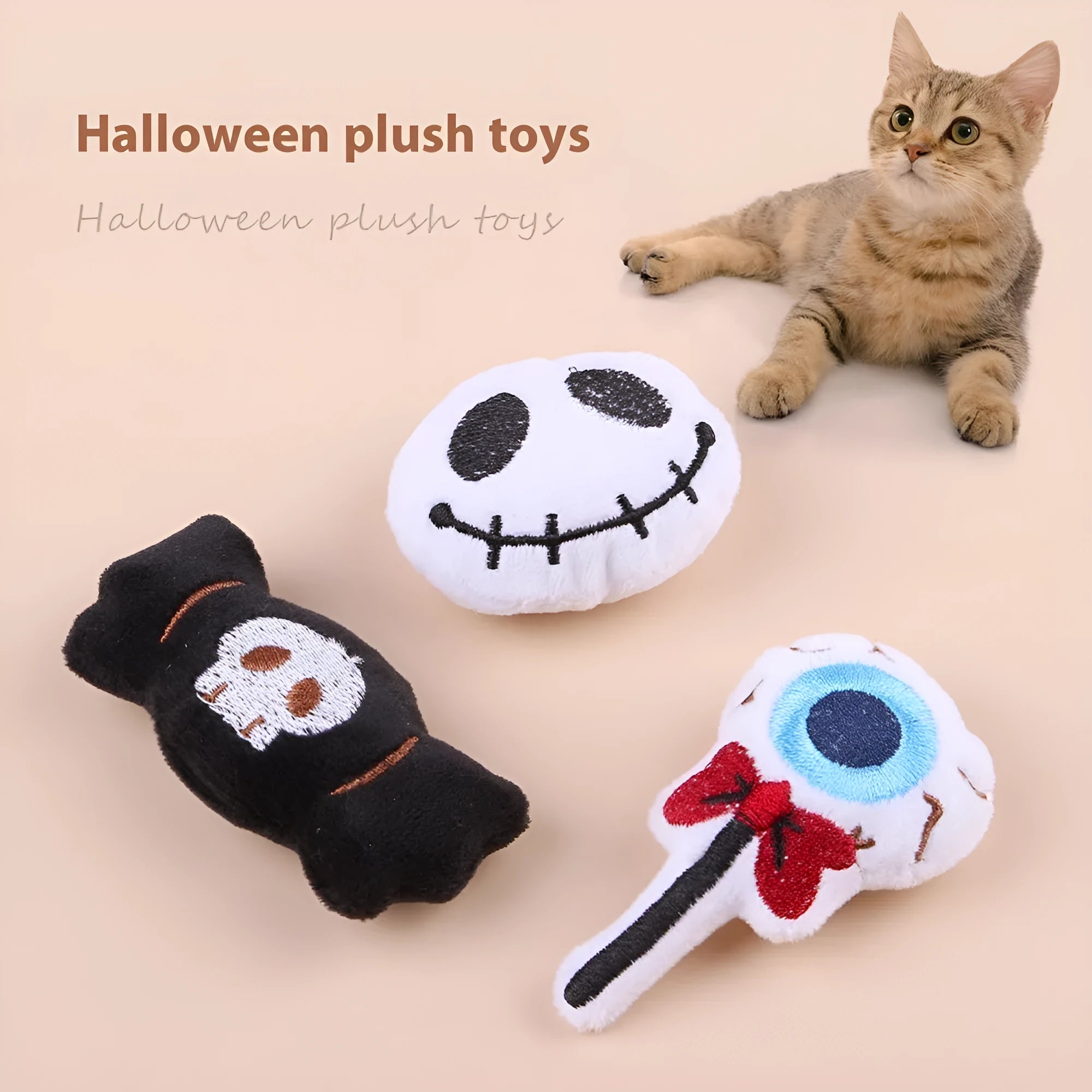 Small plush cat teaser wand with three interchangeable attachments: candy, eyes and skull designs