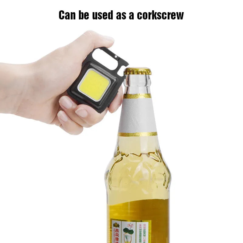 Black aluminum alloy USB rechargeable keychain light with magnetic base and foldable handle