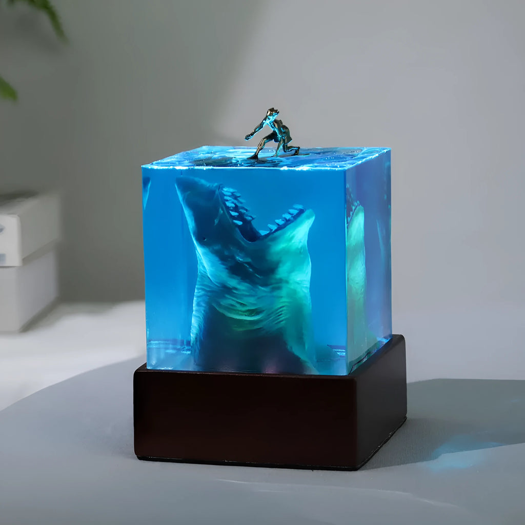 Epoxy resin shark surf scene night light ornament in 5cm and 8cm sizes on a table.