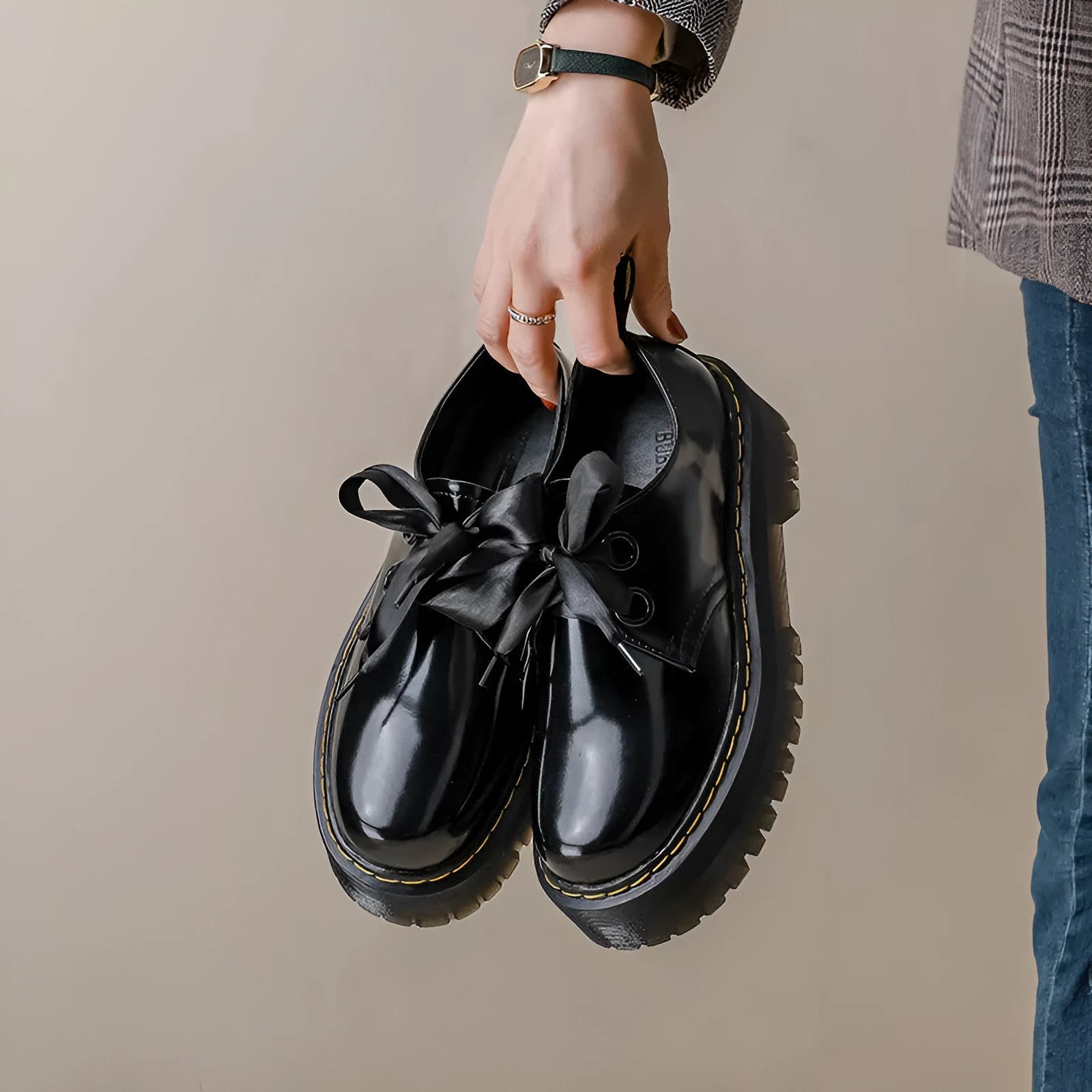 Women's black lace-up shoes with thick TPR sole, ribbon and cross strap details on superfine fibre upper.