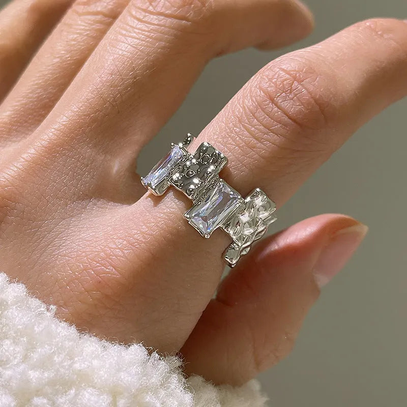 Silver geometric cross ring with zircon detailing and open gemstone setting