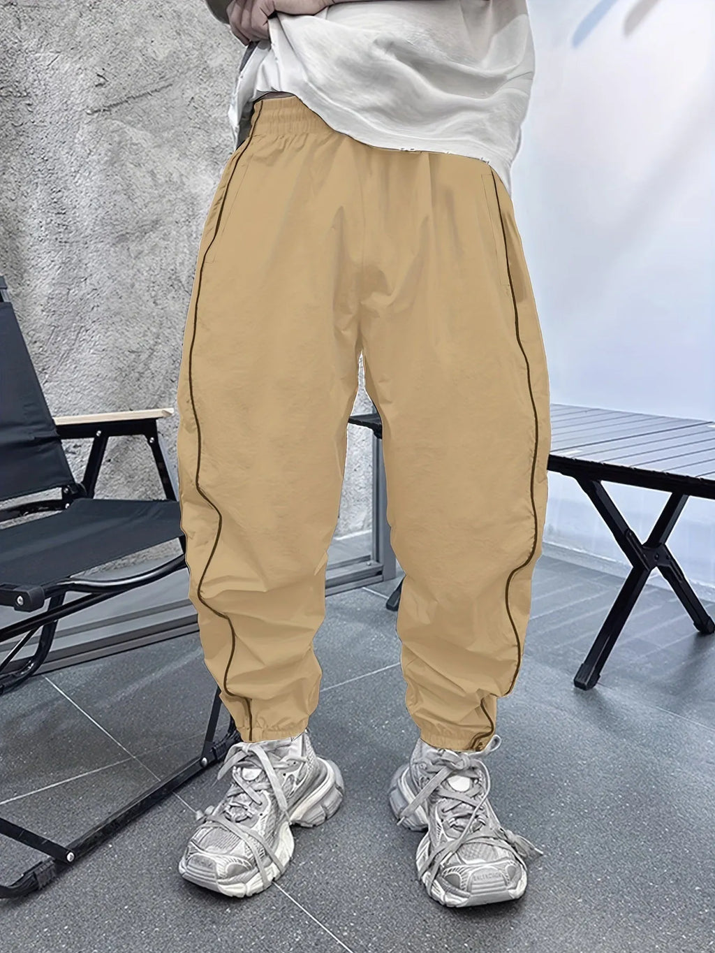 Man wearing blue loose-fit cropped sports trousers made from bamboo fibre.