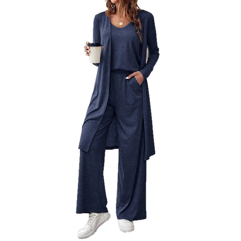 Blue women's three-piece trouser suit set with long cardigan on a hanger.