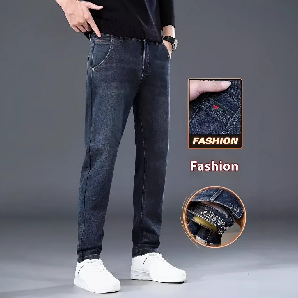 Man wearing slim straight blue-grey casual trousers with a micro-elastic fit and zipper fly.