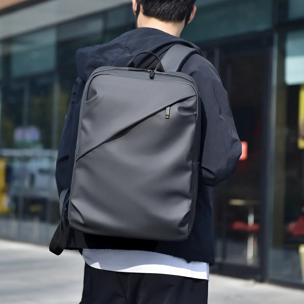 Large black waterproof PU leather backpack with sewing thread detail, shown from a side angle.