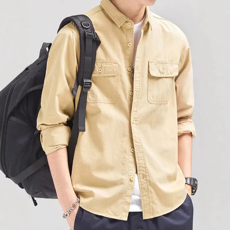 Man wearing a loose fit long sleeve overalls shirt in polyester, cardigan style.