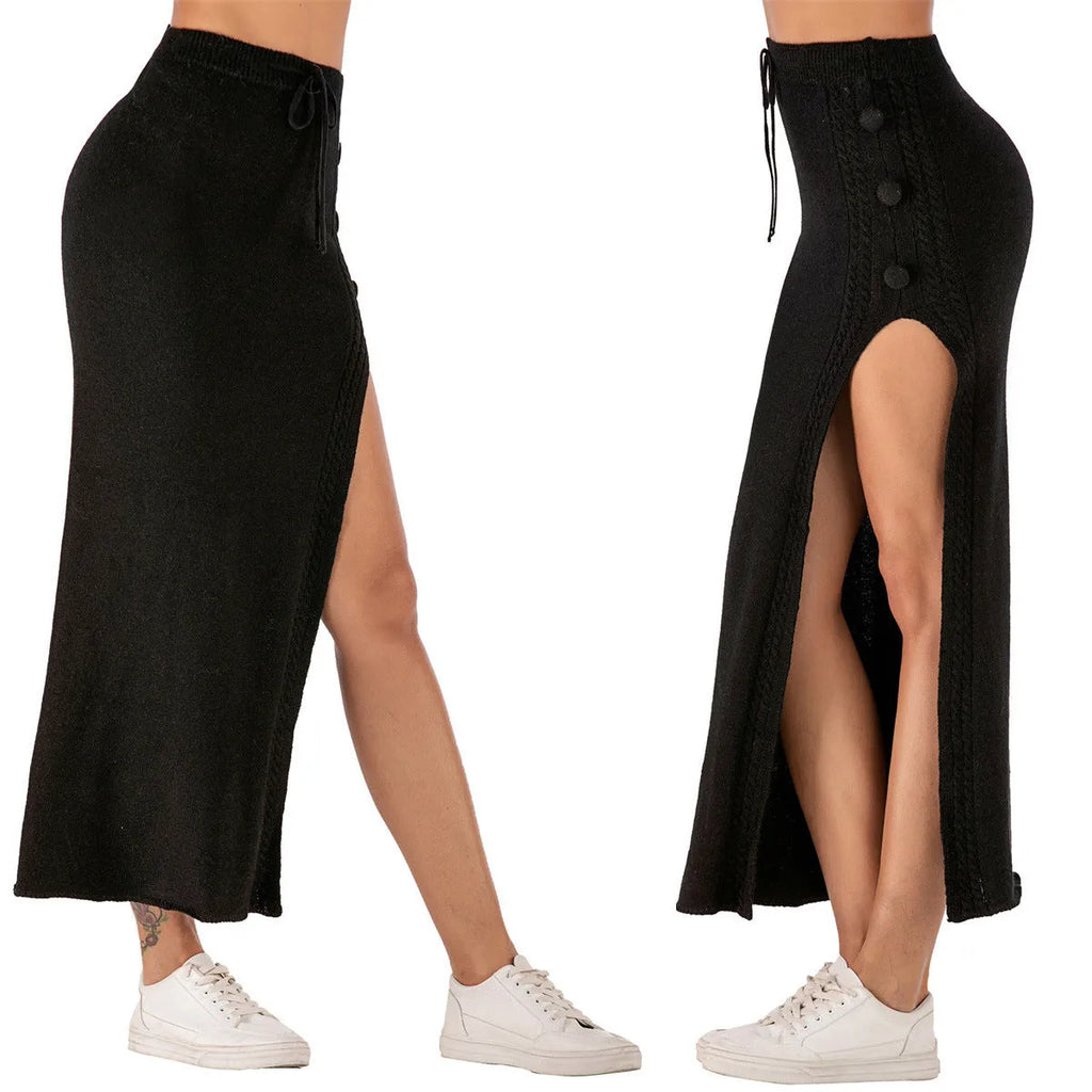 Long slim-fit acrylic woolen skirt in black with a side split and strap details on a mannequin.