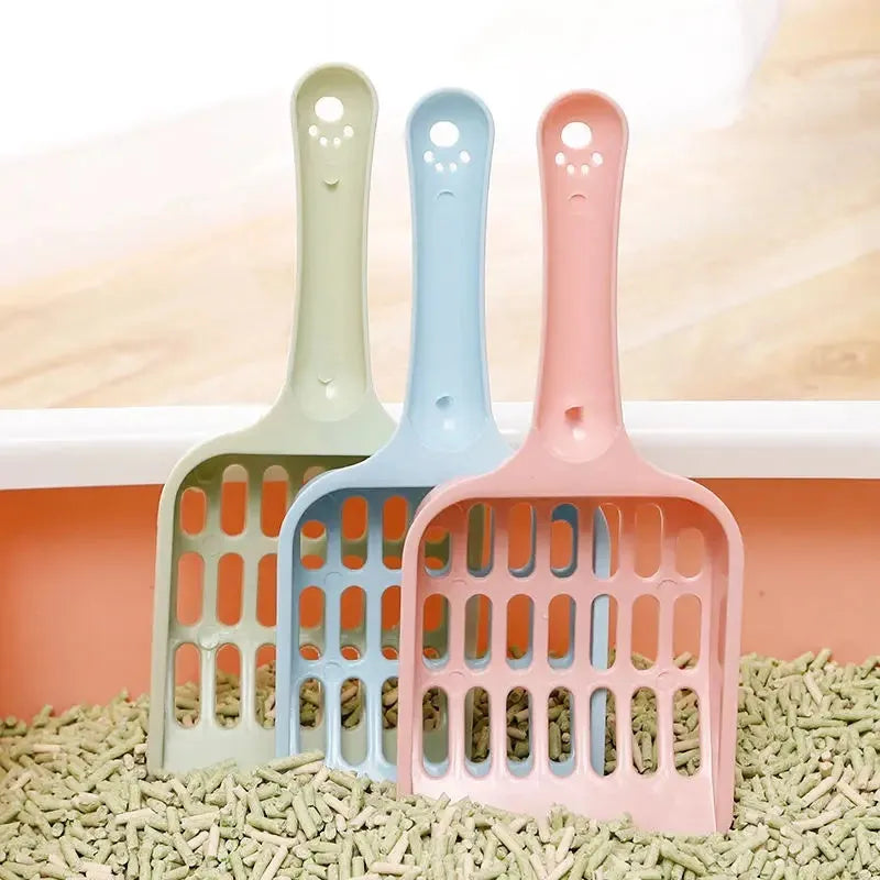 Blue plastic cat litter scoop on a white background, showing its size and sifting holes.