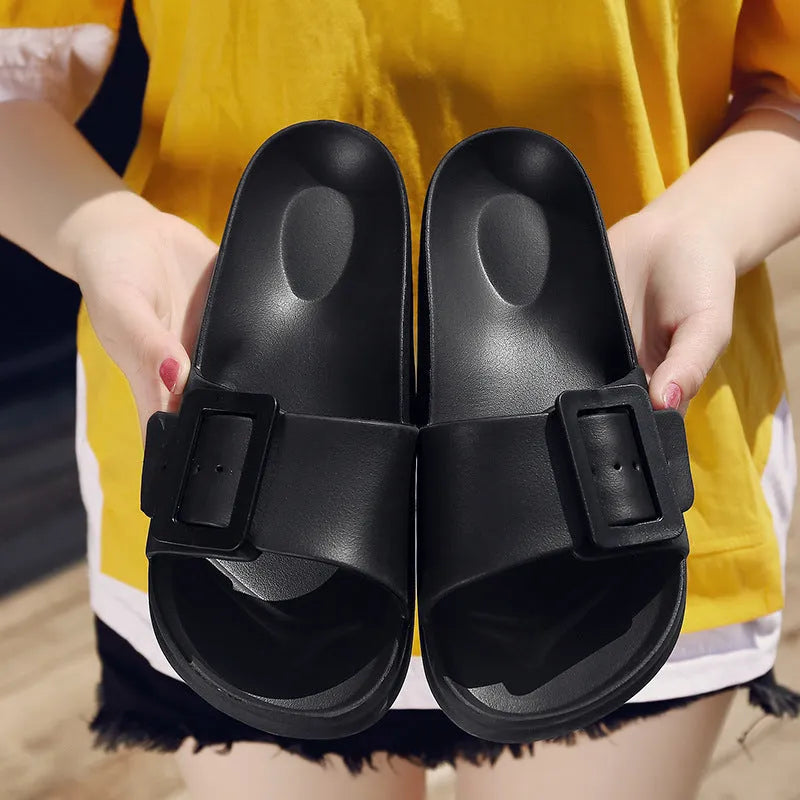 Women's grey blue buckle closure slipper sandals with soft EVA sole on a plain background.