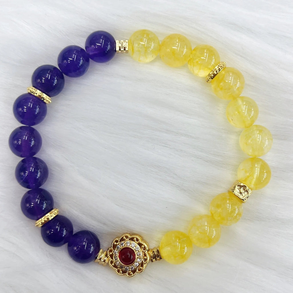 Handmade yellow and purple crystal women's bracelet on wrist.