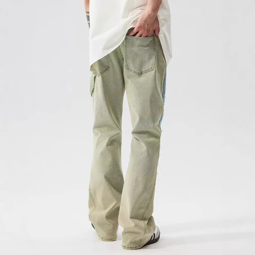 Men's yellow and blue patchwork jeans with a retro splash-ink damaged design on the legs.