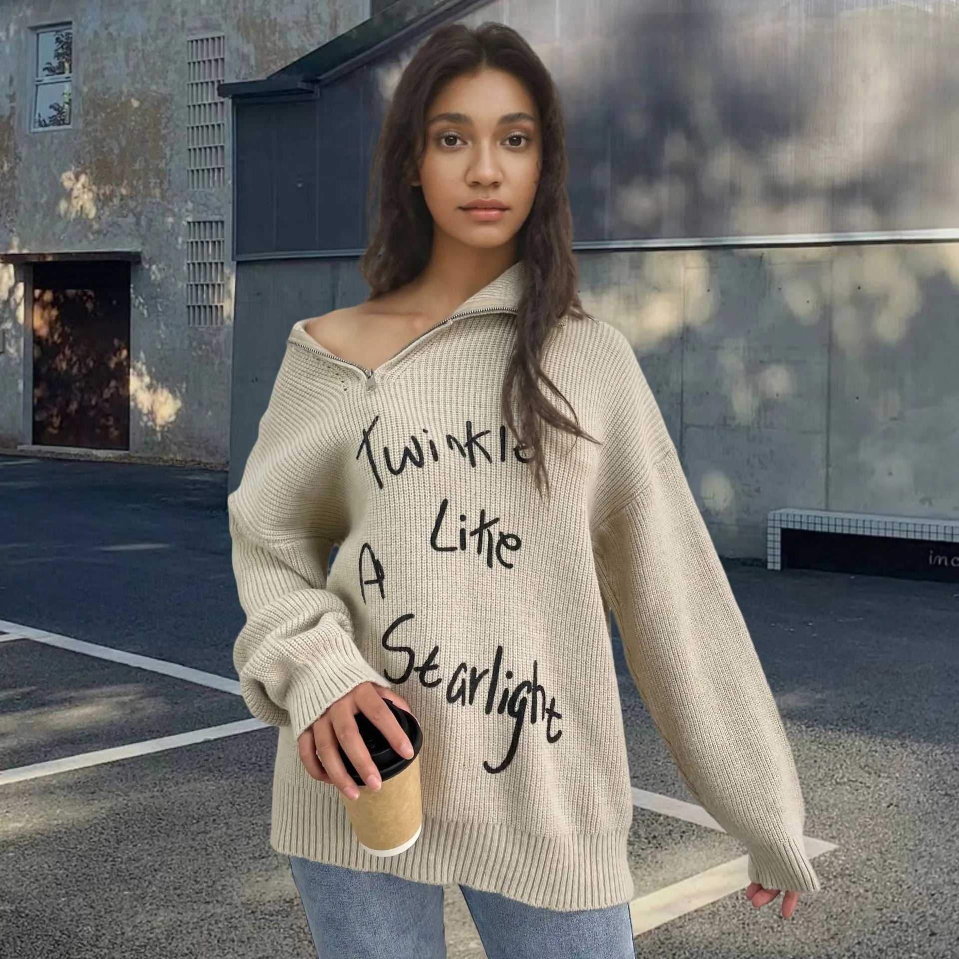 Light khaki women's alpaca wool sweater with oblique zip, turtleneck, and loose lapels.