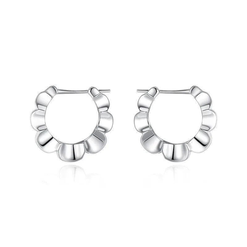 Pair of sterling silver geometric hoop earrings with round retro design elements