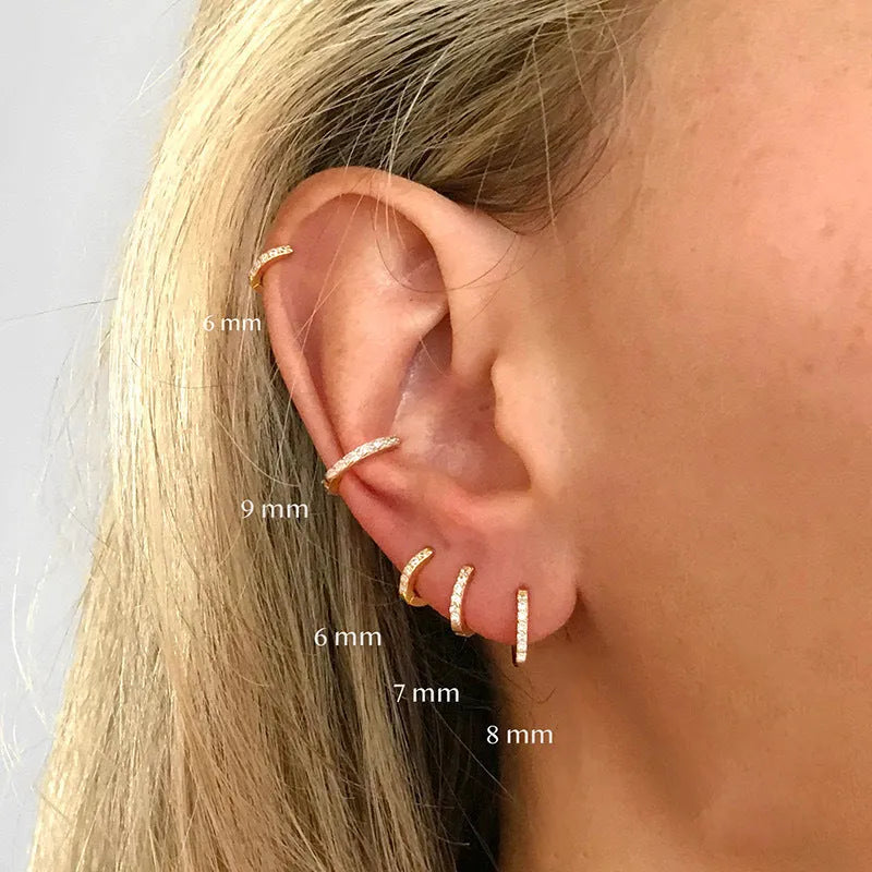 A pair of round perforated circle zircon stud earrings in gold, rose gold, and silver colour options.