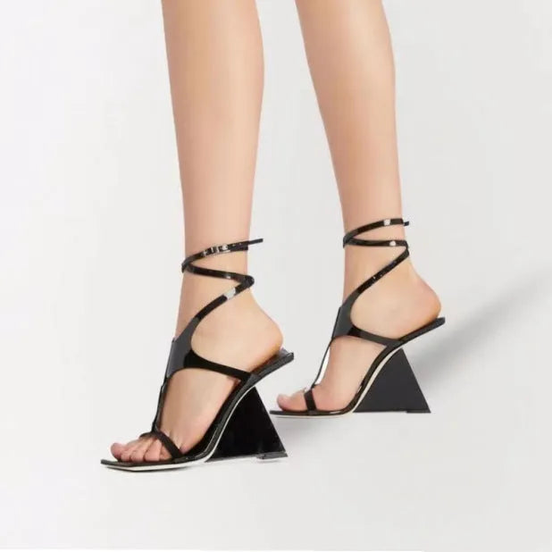 Women's black high heel sandals with a square toe and button strap fastening.