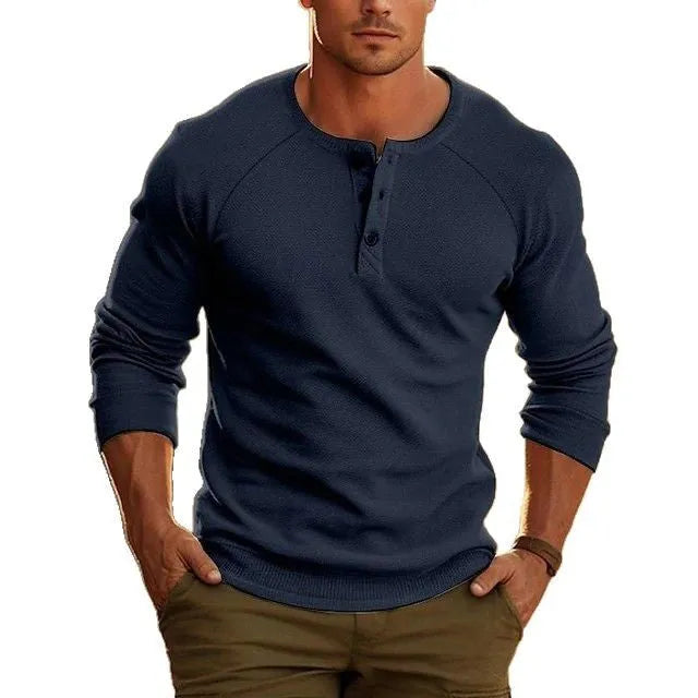 Man wearing a navy blue long-sleeved t-shirt with a henry collar, showcasing the European cut and cotton blend fabric.