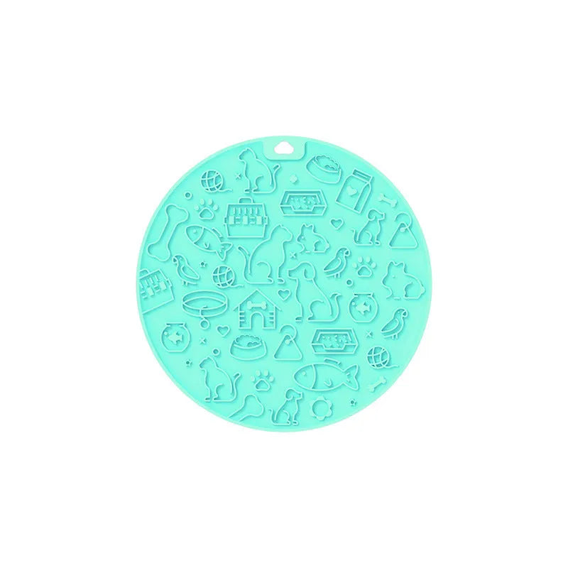 Round blue silicone pet licking mat with textured surface and a white suction cup on the base.