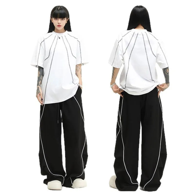 Black striped pleated hip hop trousers with wide-leg design shown flat