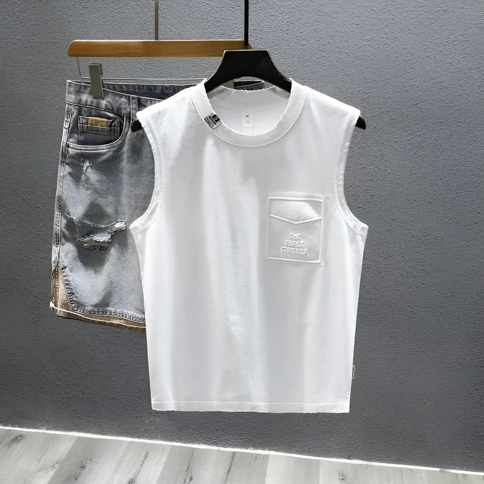 Solid colour loose cotton sleeveless t-shirt on a hanger in white or black