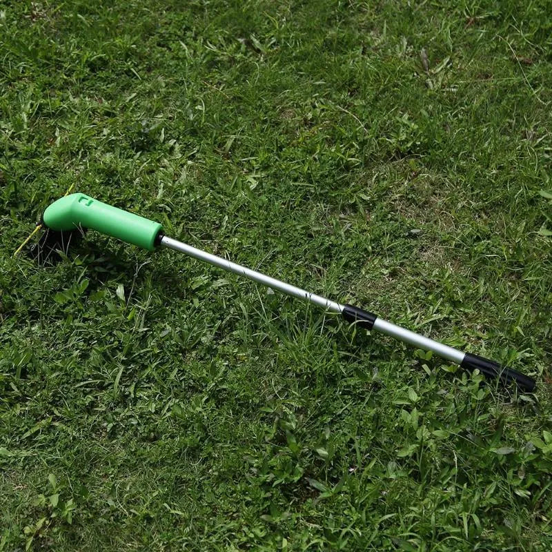 Cordless lawn trimmer with extension pole and protective shield on grass