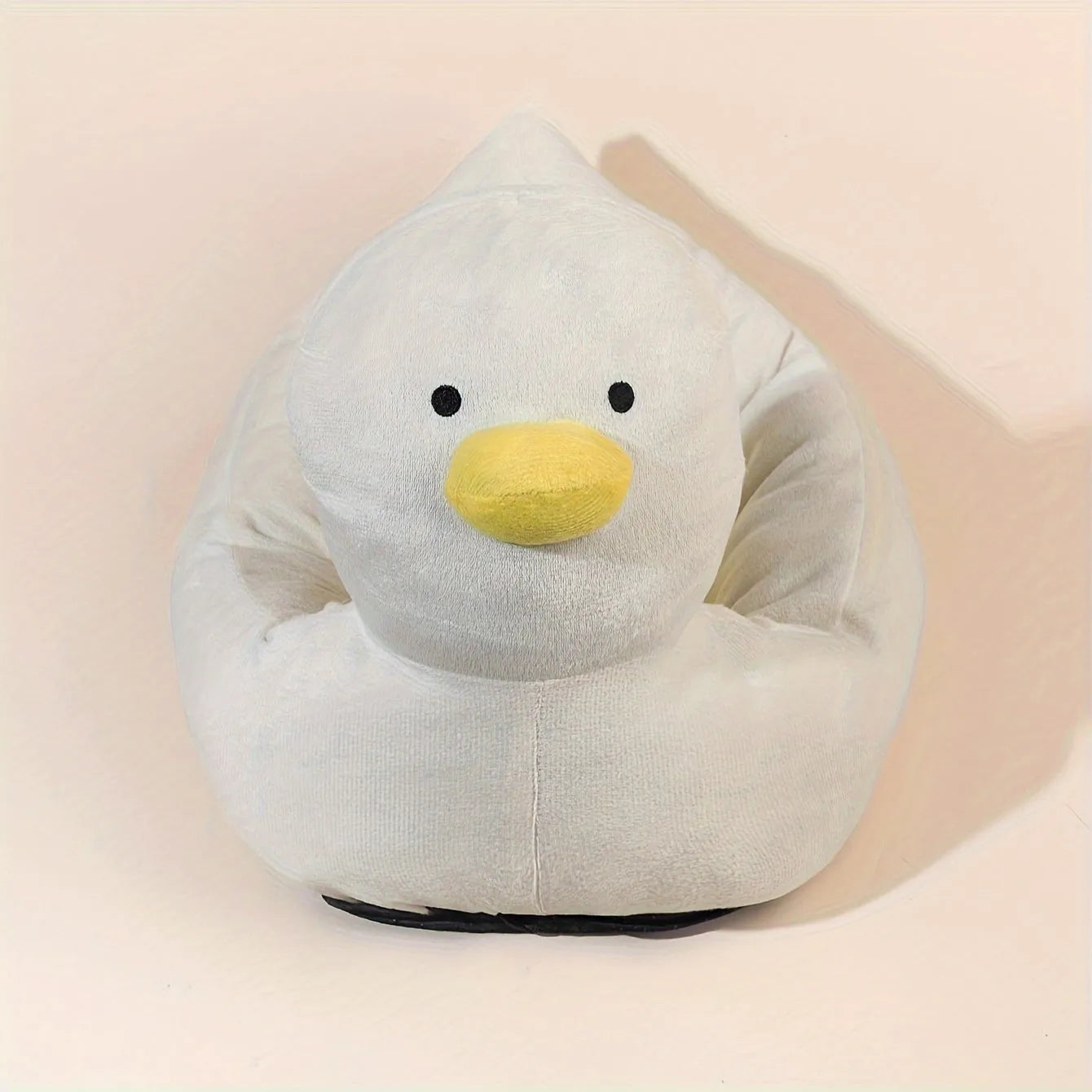 Blue duck-shaped fluffy pet bed for a small dog on a wooden floor.