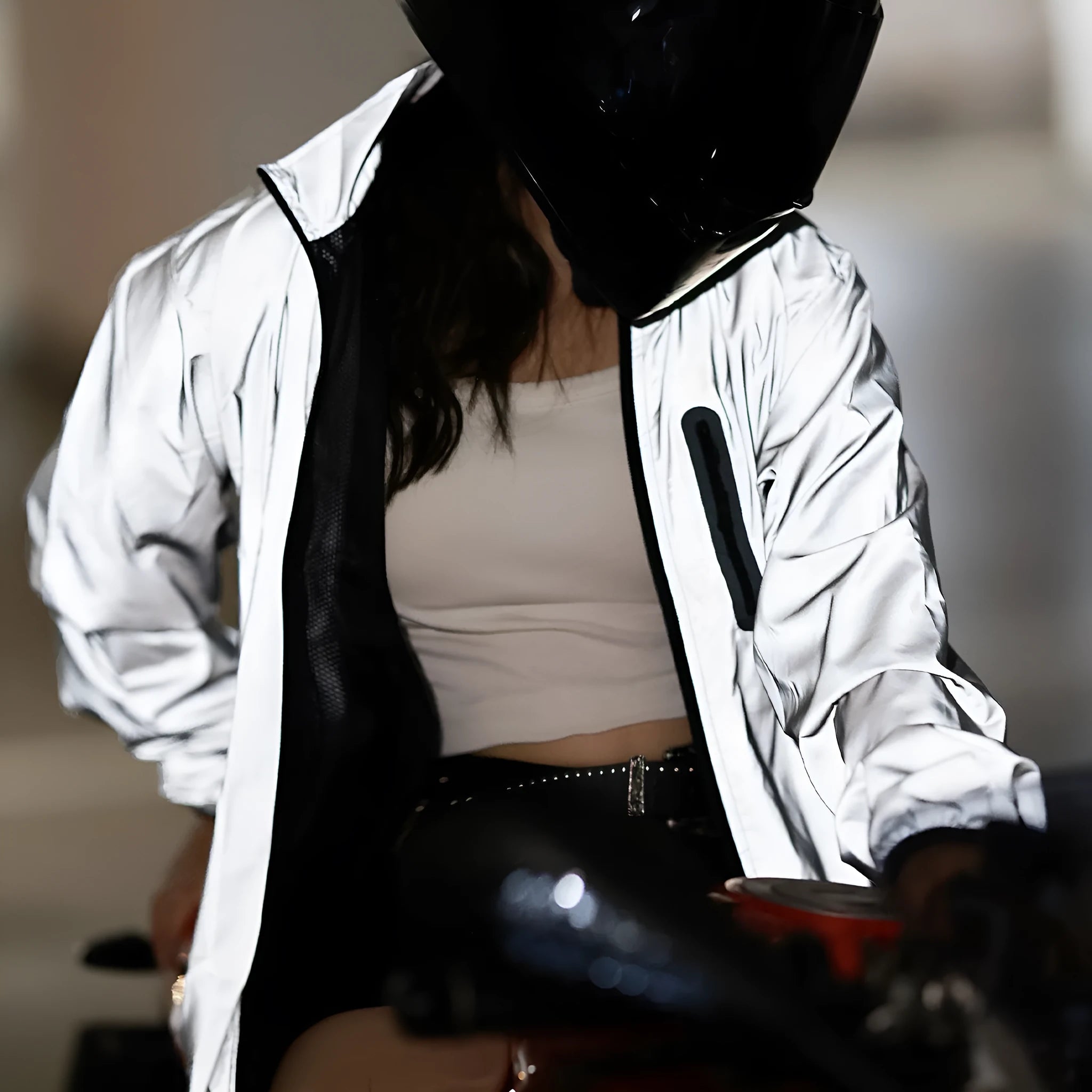 Silver waterproof polyester long sleeved coat on a hanger, showing front design.