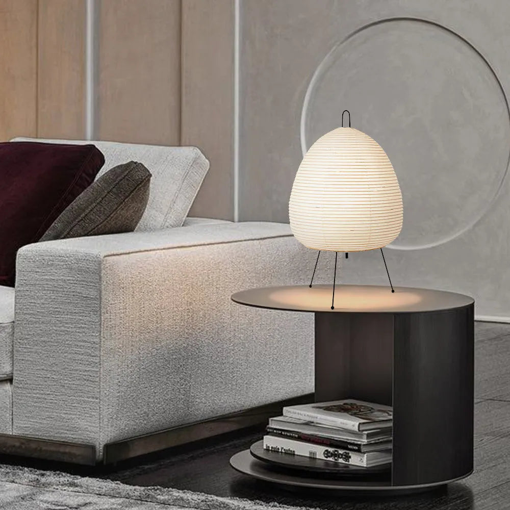 Japanese style table lamp with rice paper shade and aluminium base showing warm glow