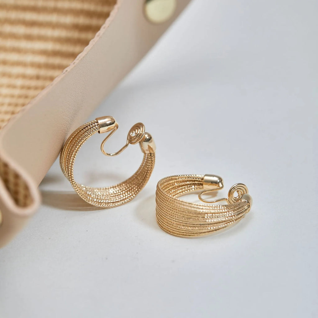 Geometric copper earrings with electroplated silver and gold finishes including stud and clip styles