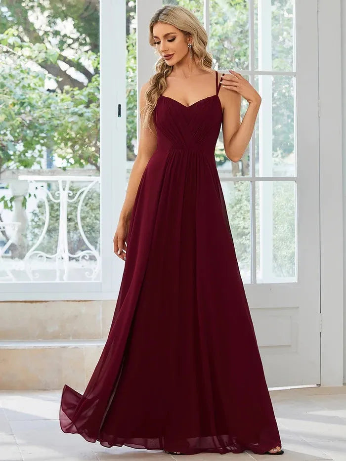 Women's sleeveless A-line pleated long dress in light green colour with sling neckline